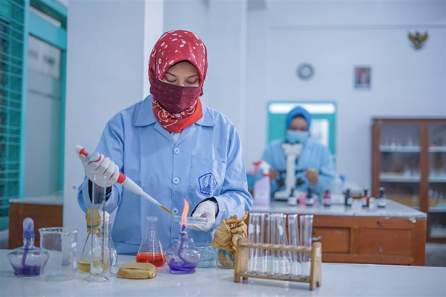 Microbiology laboratory work with glassware and specimen preparation
